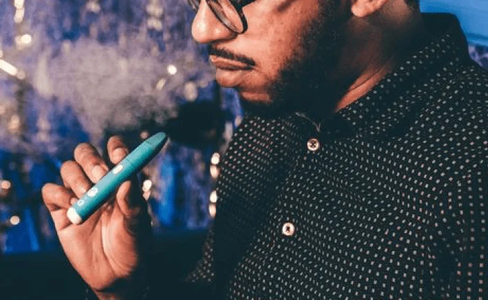 Man exhaling vapor from the Cookies x G Pen Micro+